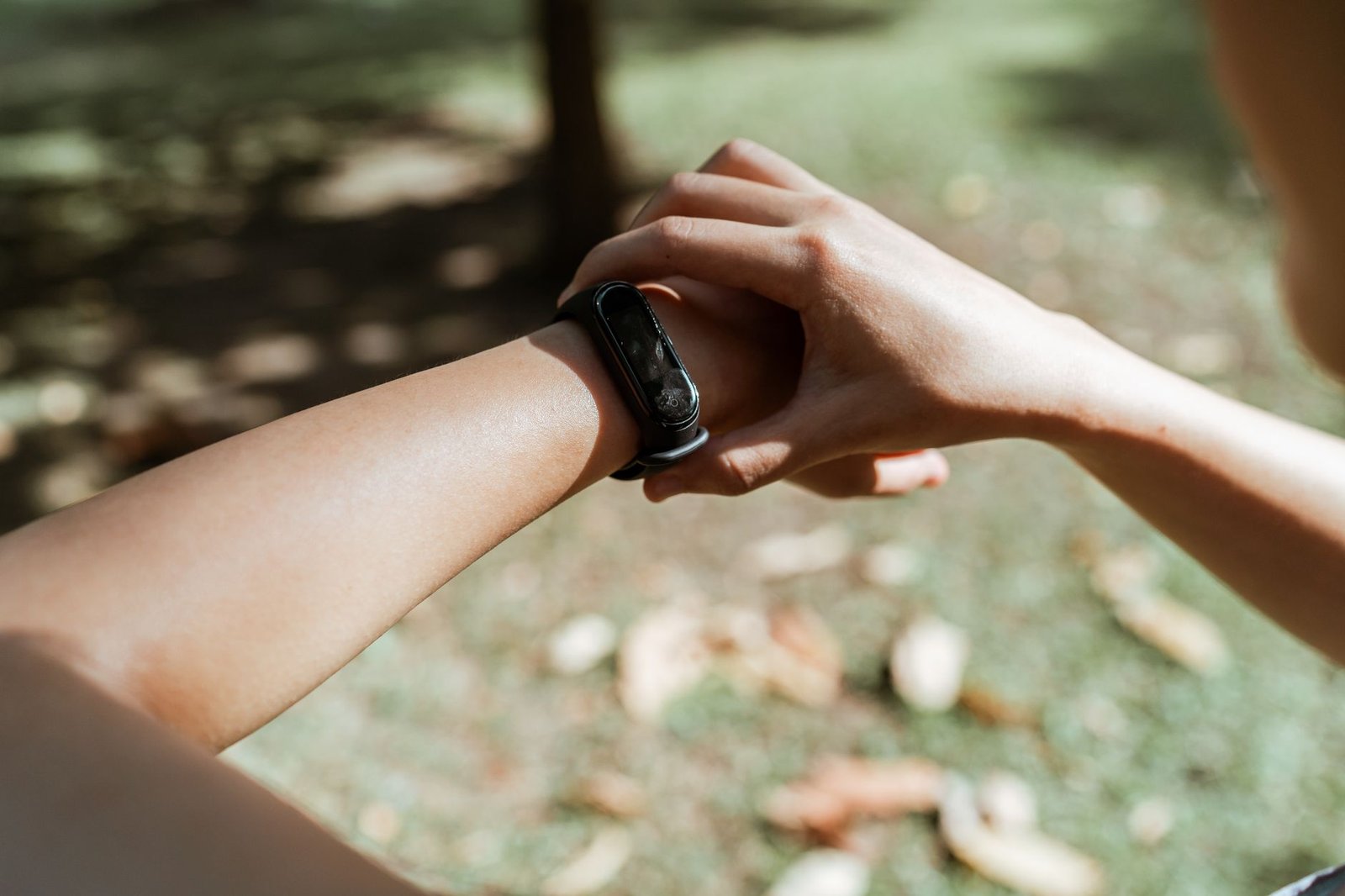 Close-up of a Fitbit Charge 6 displaying heart rate data on its screen.