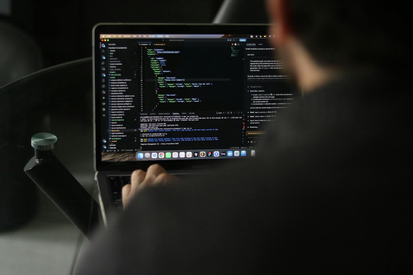 Developer working efficiently on a laptop in a well-lit home office, utilizing a cloud IDE.