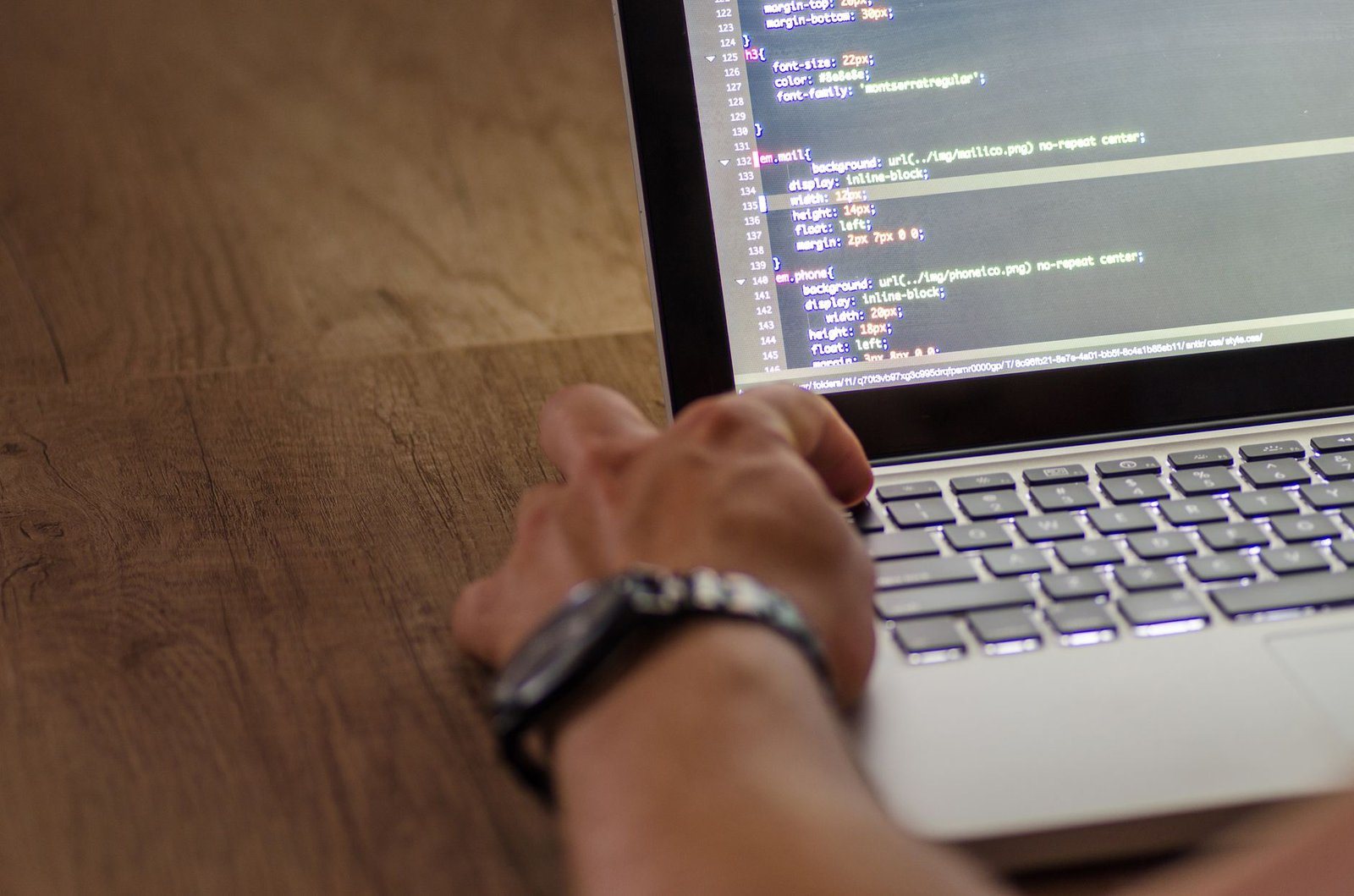 Solo developer focused on a laptop screen displaying code.
