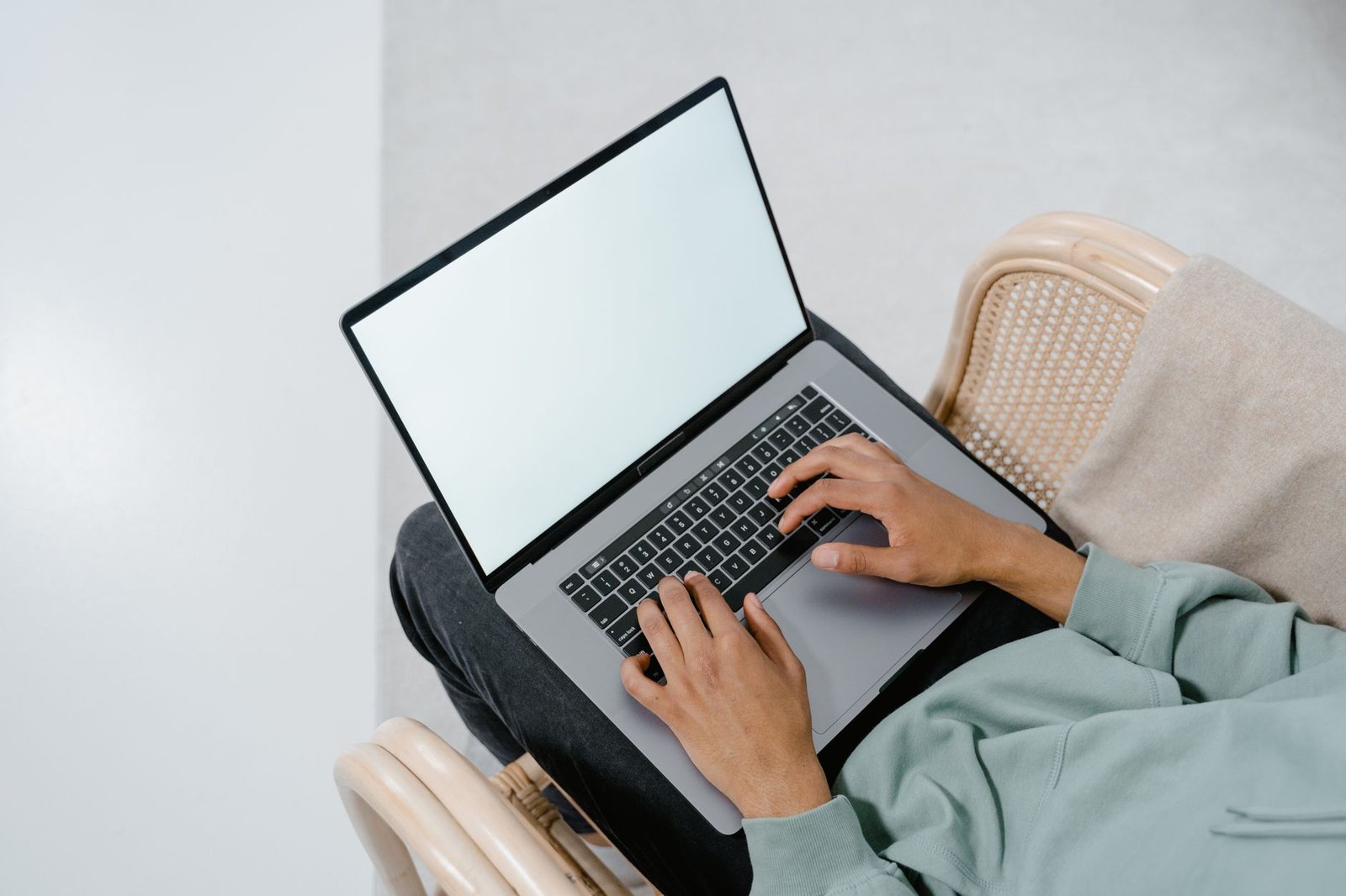 Person using a laptop to access and configure router settings.
