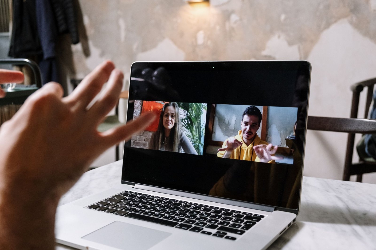 Diverse remote team collaborating happily on a video call with AI-powered communication tools visible on screen.
