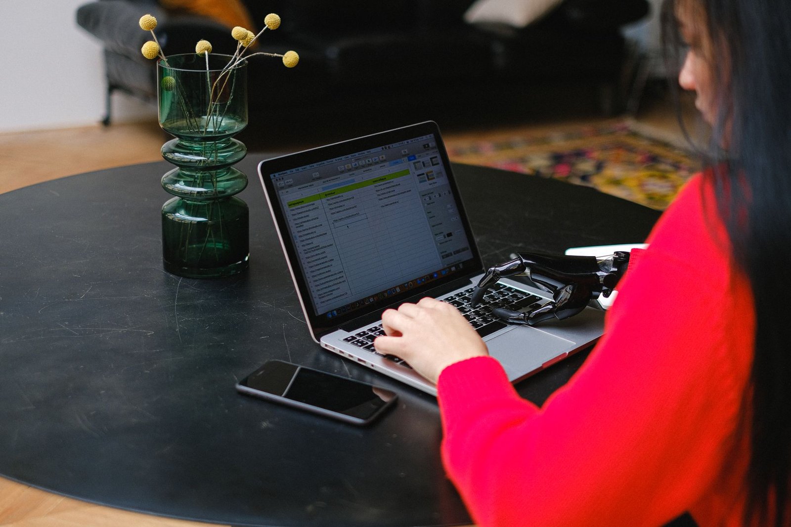 A remote worker efficiently managing tasks with the help of an AI virtual assistant on their laptop.