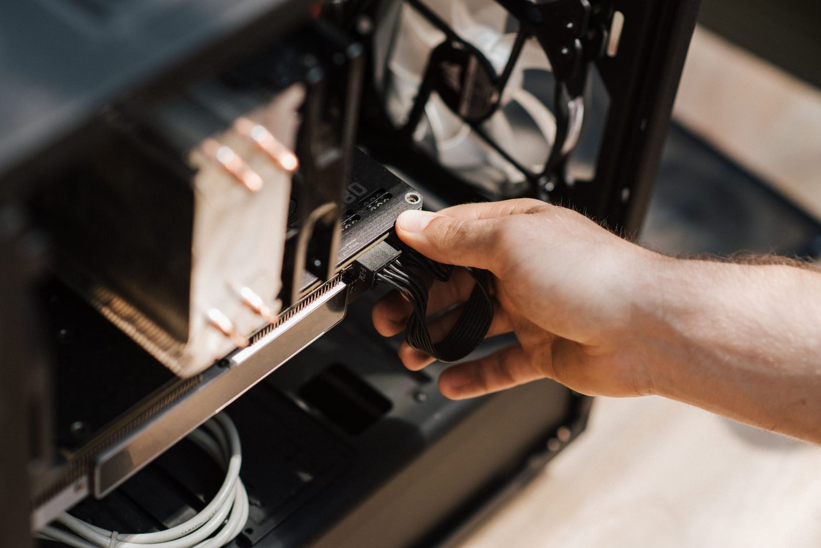 Technician installing a solid state drive into a gaming desktop PC