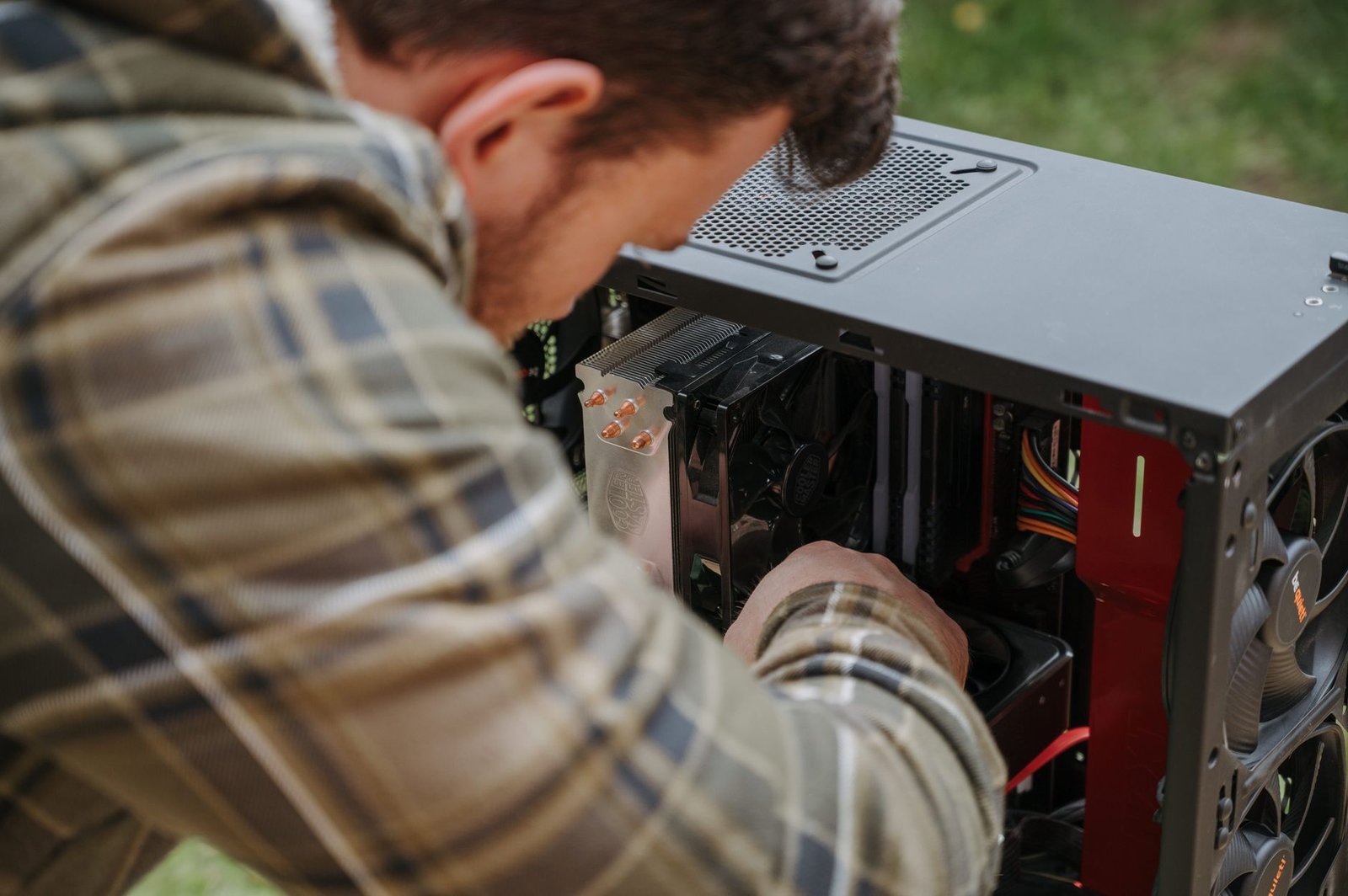 Close-up of a hand installing a new SSD into a computer's motherboard slot.