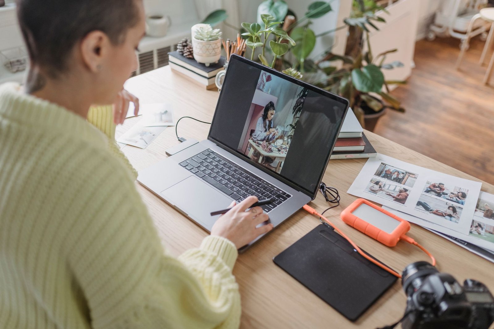 Photographer managing digital photos on a computer.